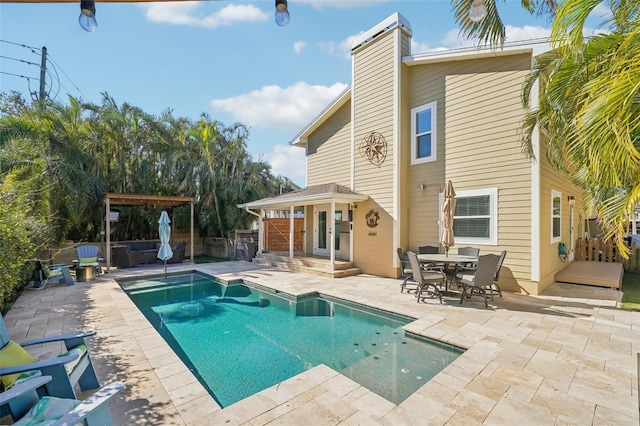 13945 75th Ave, Seminole, FL 33776 - back of property featuring a patio area, a chimney, fence, and outdoor dining space