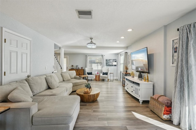 13945 75th Ave, Seminole, FL 33776 - living area with wood finished floors, recessed lighting, stairway, and a textured ceiling