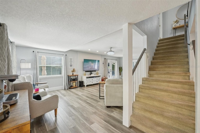 13945 75th Ave, Seminole, FL 33776 - living room featuring stairway, wood finished floors, a textured ceiling, baseboards, and recessed lighting