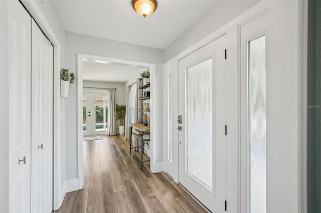 13945 75th Ave, Seminole, FL 33776 - entryway with french doors, wood finished floors, and baseboards
