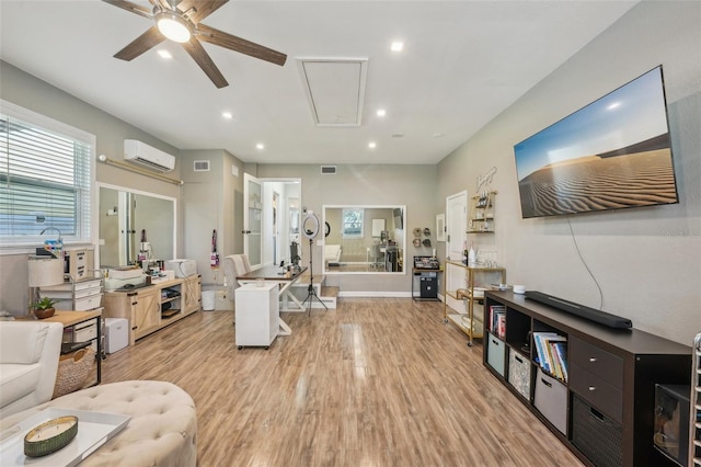 13945 75th Ave, Seminole, FL 33776 - living room featuring attic access, ceiling fan, an AC wall unit, light wood finished floors, and plenty of natural light