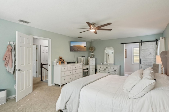 13945 75th Ave, Seminole, FL 33776 - bedroom with light colored carpet, a barn door, a ceiling fan, and baseboards