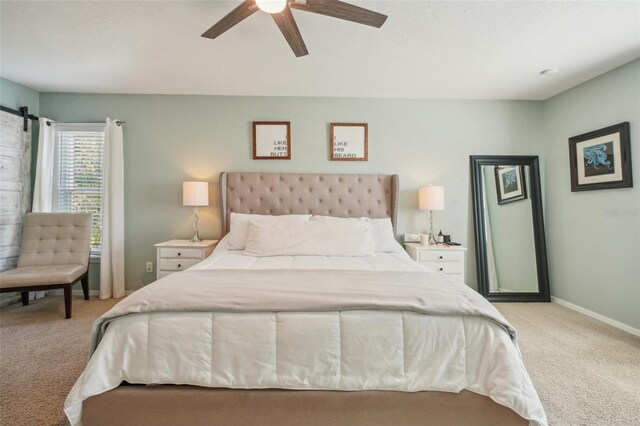 13945 75th Ave, Seminole, FL 33776 - bedroom featuring light colored carpet, ceiling fan, and baseboards