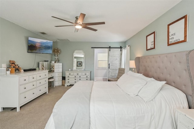 13945 75th Ave, Seminole, FL 33776 - bedroom with light colored carpet, a barn door, and ceiling fan