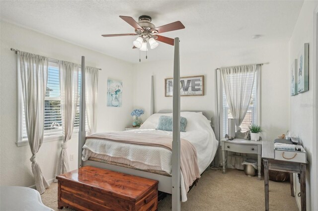 13945 75th Ave, Seminole, FL 33776 - bedroom with light carpet and a ceiling fan