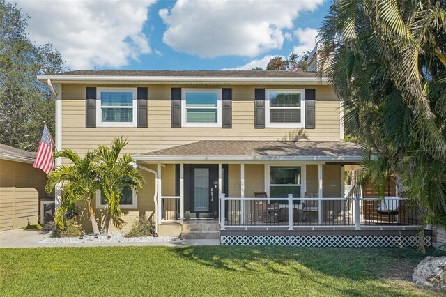 13945 75th Ave, Seminole, FL 33776 - view of front of house featuring a front yard and a porch
