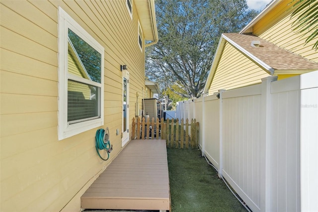 13945 75th Ave, Seminole, FL 33776 - view of property exterior featuring fence and roof with shingles