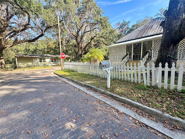 view of side of home with covered porch