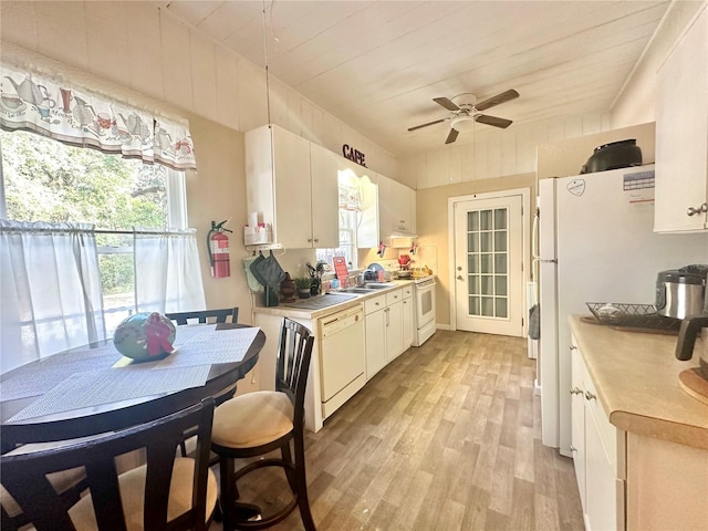 kitchen with white cabinets, ceiling fan, light hardwood / wood-style floors, and white appliances