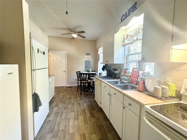 kitchen with white appliances, ceiling fan, dark wood-type flooring, sink, and white cabinets