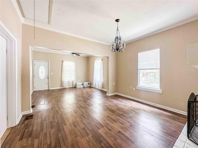 interior space featuring ornamental molding, wood finished floors, and a healthy amount of sunlight