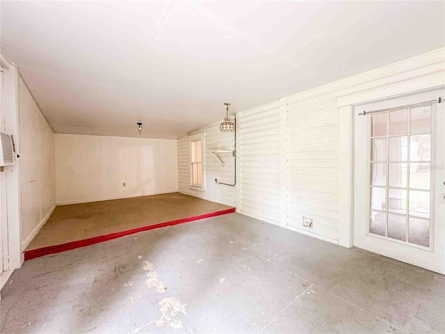 unfurnished room featuring concrete floors