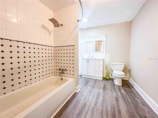 full bath with vanity, baseboards, toilet, shower / bathing tub combination, and wood finished floors