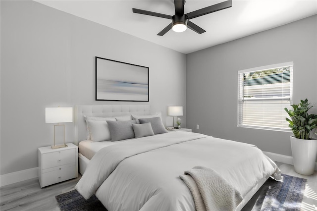 bedroom with light hardwood / wood-style floors and ceiling fan