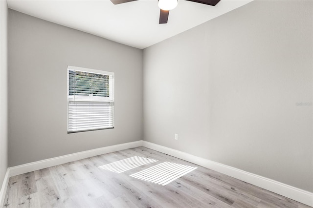 empty room with ceiling fan and light hardwood / wood-style flooring