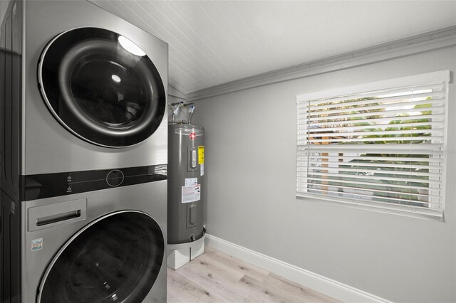 clothes washing area with stacked washer and dryer, light hardwood / wood-style flooring, ornamental molding, and electric water heater