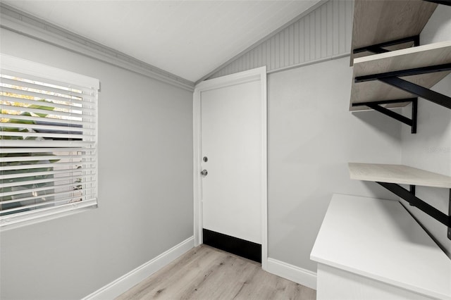 interior space featuring lofted ceiling and light hardwood / wood-style flooring