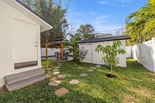 view of yard with a shed, a gazebo, and a patio area