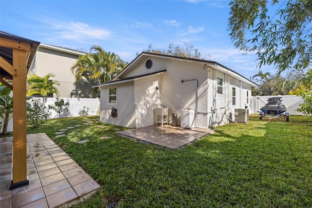 back of house featuring a yard and a patio