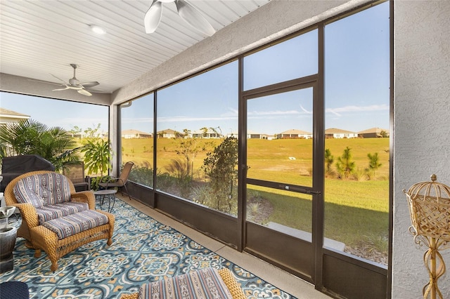 sunroom featuring ceiling fan