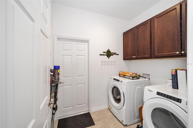 clothes washing area with cabinets and independent washer and dryer