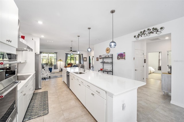 kitchen with pendant lighting, white cabinetry, and a kitchen island with sink