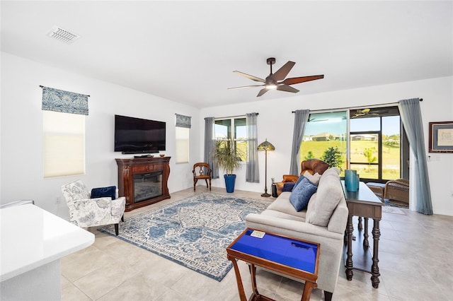 living room featuring light tile patterned floors and ceiling fan