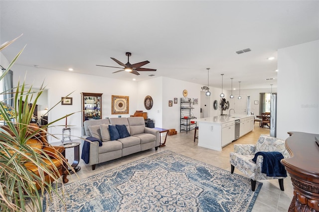 living room featuring ceiling fan and sink