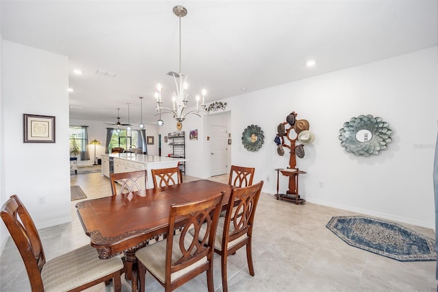 dining room with ceiling fan with notable chandelier