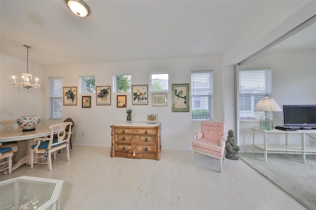 interior space with light wood-type flooring and a chandelier