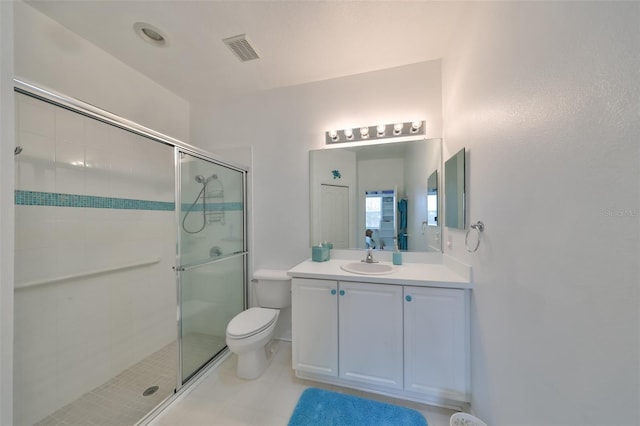 bathroom featuring toilet, a shower with shower door, and vanity