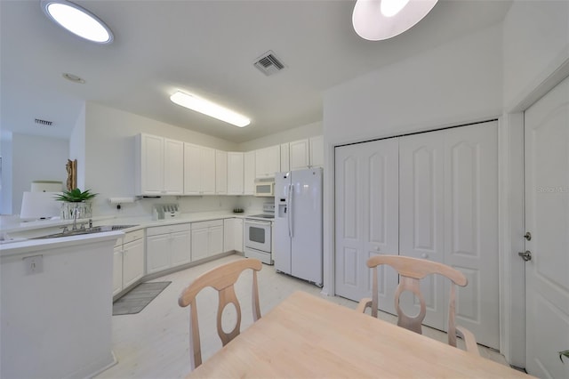 kitchen with white cabinets and white appliances