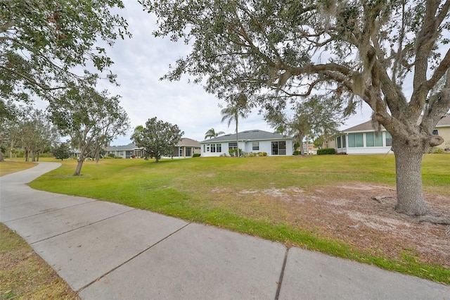 single story home with a front lawn