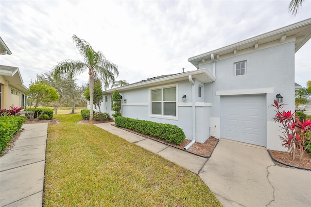 view of front of home with a garage and a front yard