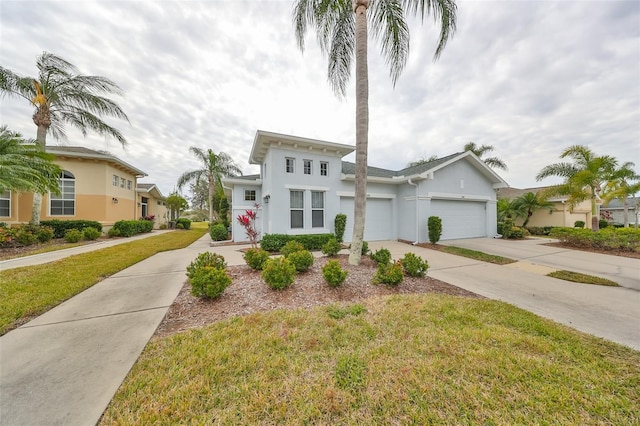 view of front of house with a garage and a front yard