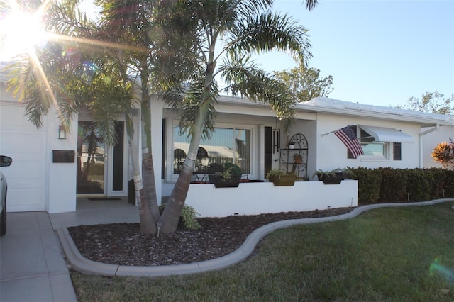 view of front facade with a garage and a front lawn