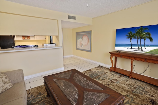 tiled living room with a textured ceiling