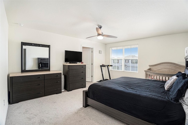 carpeted bedroom with a textured ceiling and ceiling fan