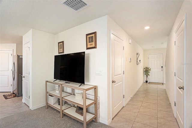 hallway with light tile patterned floors