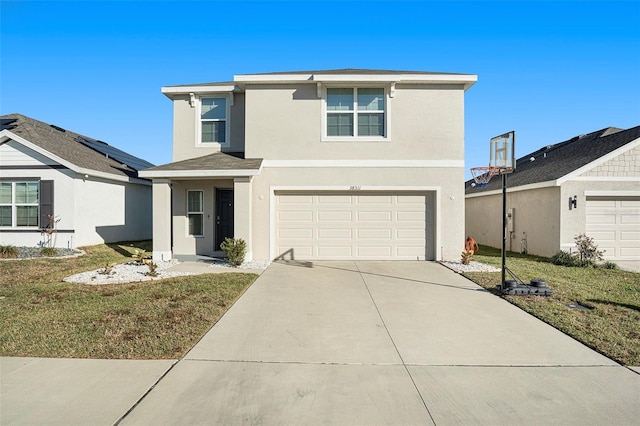 view of property featuring a garage and a front lawn