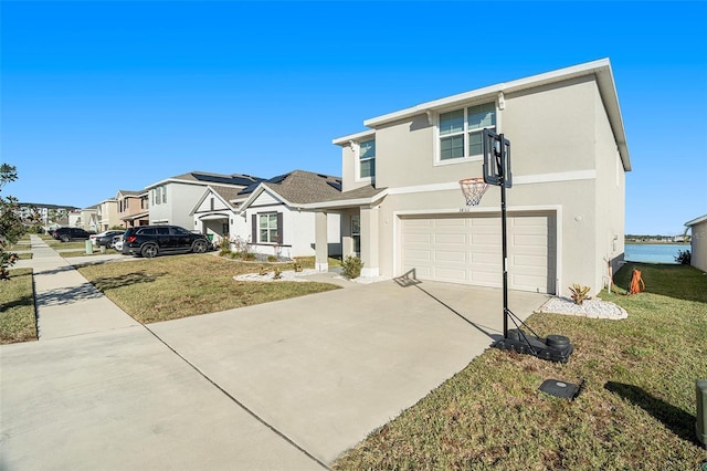 view of front of property with a front yard and a garage