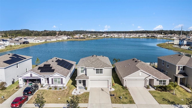 drone / aerial view with a water view and a residential view