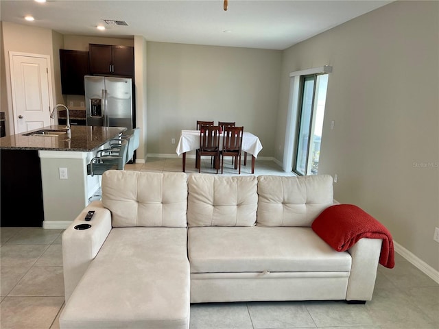 living room with sink and light tile patterned floors