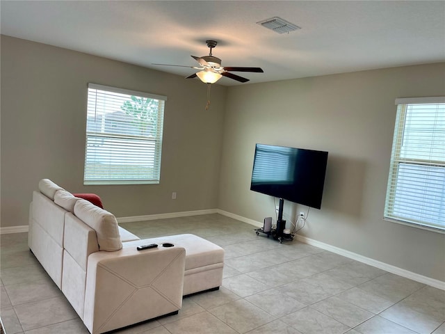 living room featuring ceiling fan and light tile patterned floors