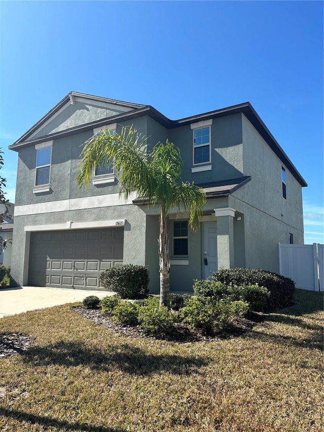 view of front facade with a garage and a front yard