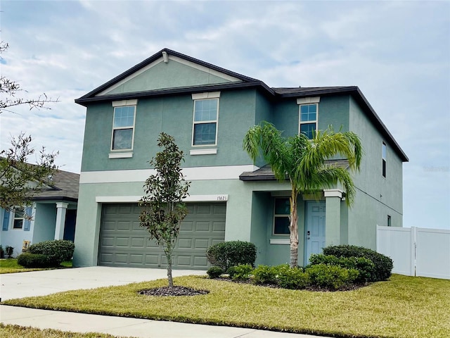 13621 Willow Bluestar Loop, Riverview, FL 33579 - view of front of home with stucco siding, an attached garage, and driveway