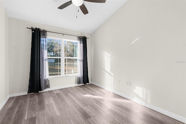 unfurnished room with ceiling fan, light hardwood / wood-style flooring, and lofted ceiling