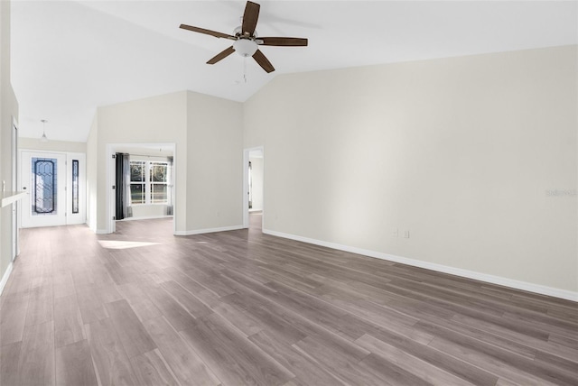 unfurnished living room with hardwood / wood-style floors, high vaulted ceiling, and ceiling fan