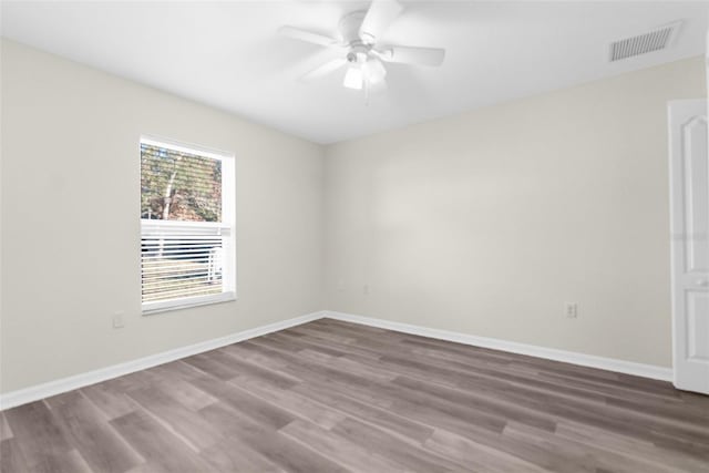 spare room featuring wood-type flooring and ceiling fan