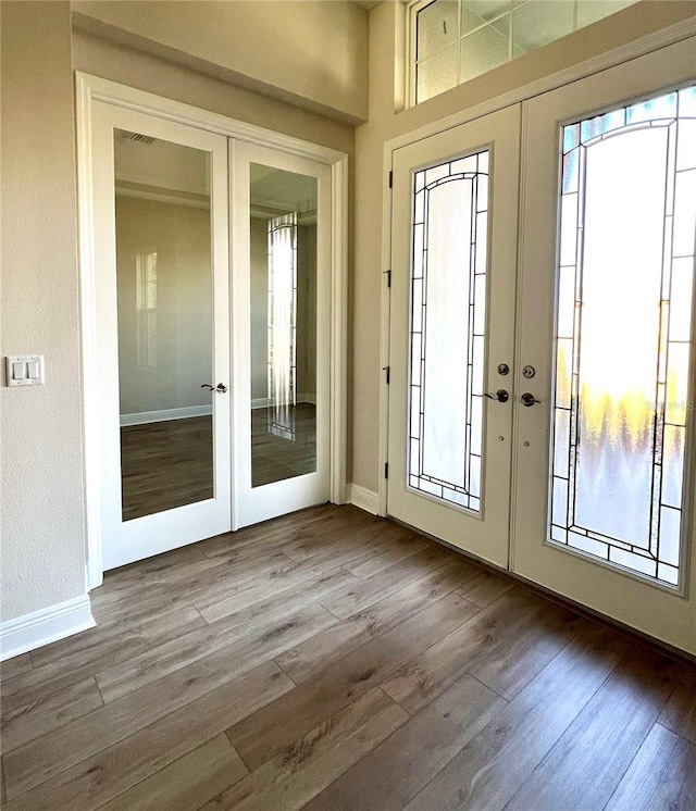 entryway with hardwood / wood-style flooring and french doors